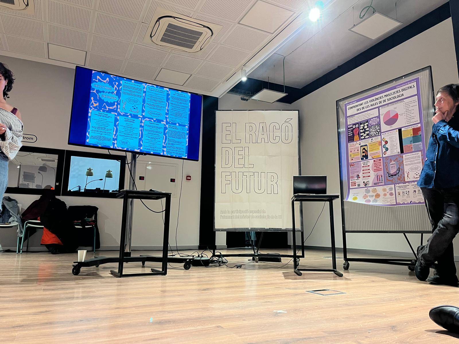 Pantalla de materials i pòster de COVIMADI exposats durant l’activitat.